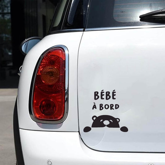 Décalcomanie ours accroché au bord, graphisme en vinyle noir découpé.