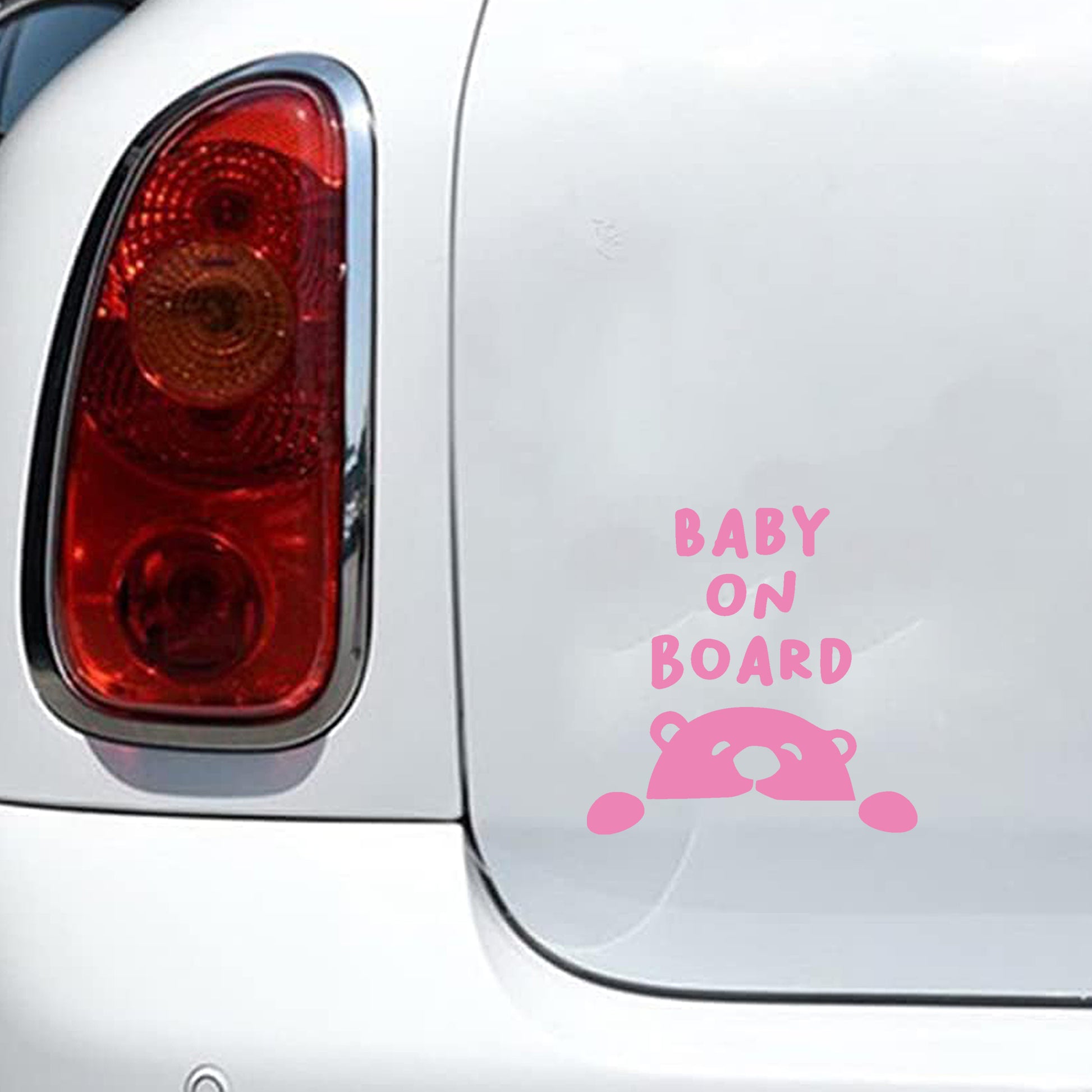 Baby bear peeking car decal, pink nursery-style accessory for parents.
